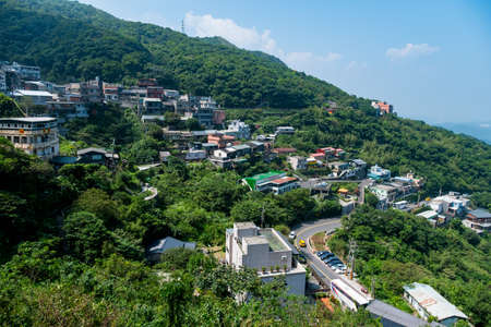 landscape view of JiuFen Village with mountain residental buildings and blue sky. Ruifang District, New Taipei City, Taiwanのeditorial素材