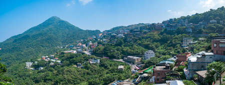 landscape view of JiuFen Village with mountain residental buildings and blue sky. Ruifang District, New Taipei City, Taiwanのeditorial素材