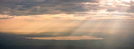 Sunrise scene, Panorama landscape view of the mountain and clouds. Sun rays through the clouds. Beautiful sunrise over the mountain range and sea clouds in Doi Luang National Park, Payao, Thailand.の写真素材