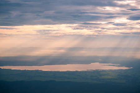 Sunrise scene, Panorama landscape view of the mountain and clouds. Sun rays through the clouds. Beautiful sunrise over the mountain range and sea clouds in Doi Luang National Park, Payao, Thailand.の写真素材