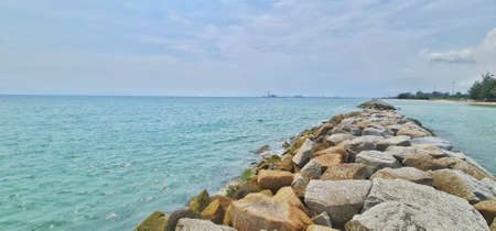 Views on large rocks built to protect against waves. Looking as far as the eye can see is the deep sea port of Thailand.の写真素材