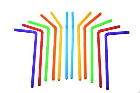 Blue, yellow, orange, green, red and blue drinking straws arranged on a white background.の写真素材