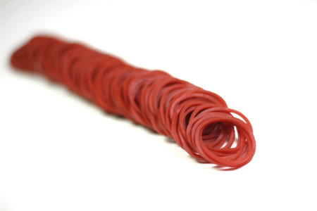 Red rubber bands arranged in long, deep corners.の写真素材