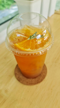 Orange juice mixed with punch Garnished with orange pulp and rosemary leaves.の写真素材