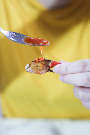 Dipping Sauce Poured on Mud Crab Claw Meat