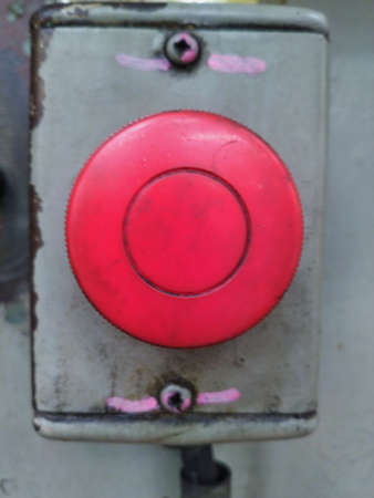 The emergency button has been installed on the machine for many years until it looks old.の写真素材