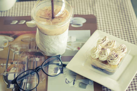 Coffee and banoffee and glasses on the table.の写真素材