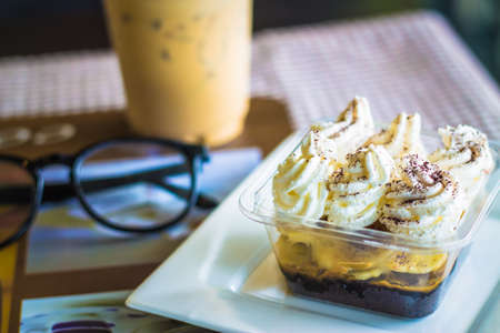 Coffee and banoffee and glasses on the table.の写真素材