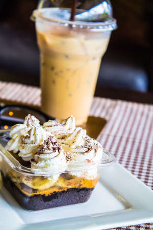 Coffee and banoffee and glasses on the table.の写真素材