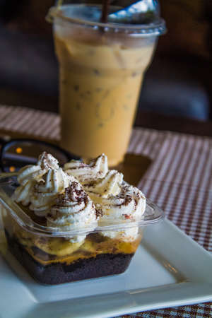 Coffee and banoffee and glasses on the table.の写真素材