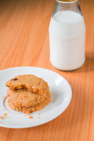 Cookies and milk placed on a wooden table.の写真素材