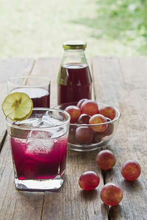Grape juice on woodの写真素材