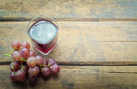 Grape juice on woodの写真素材