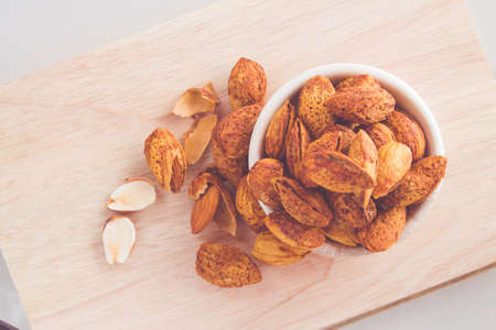 Almond paste in a cup on a wooden cutting board.の写真素材