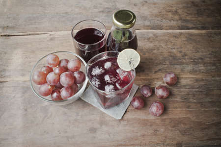 Grape juice on a wood background.の写真素材