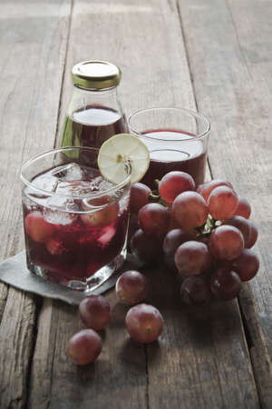 Grape juice on a wood background.の写真素材