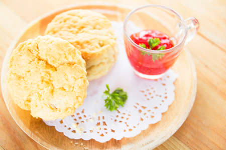 desserts, scones and strawberry jam on wood.の写真素材