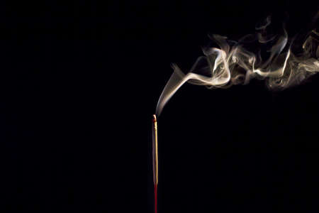 Incense Stick with Smoke on Black in black and white abstract background.の写真素材