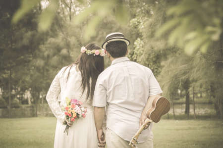 Four hands move backward wedding Vintage blurred background.の写真素材
