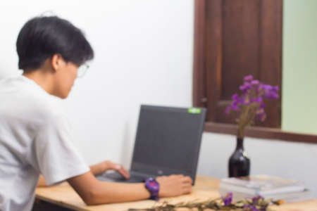 Abstract people sitting at the laptop task, leveraging heavily blurred background.の写真素材