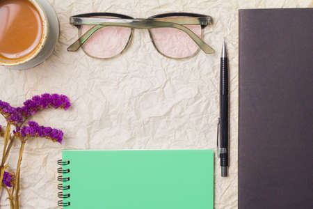 Cups, glasses, pencil on notebook paper background.の写真素材