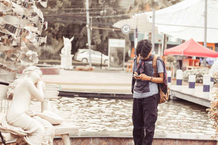 Blur tourists in Thailand are holding a mobile view vintage tone.の写真素材