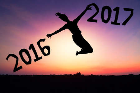Female jumping silhouette Concept natural light New Year 2017 Sunset background.の写真素材
