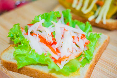 Sandwich with lettuce and crab on wood.の写真素材