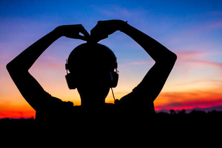 People with heart and hand Silhouette sunset blur for background.の写真素材
