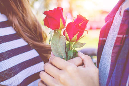 Men give women rose on Valentine's day.の写真素材