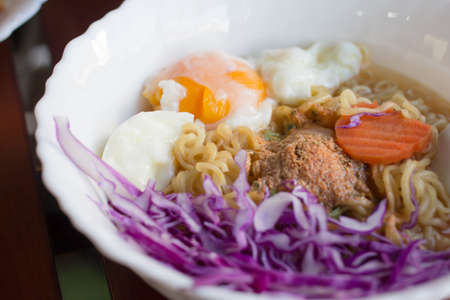 Instant noodles in cup on wood.の写真素材