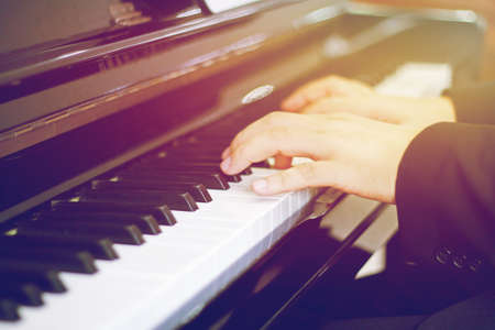  Blur Playing piano with light sunset background.