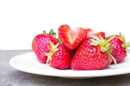 strawberry in a dish placed on the wood isolated  white background.