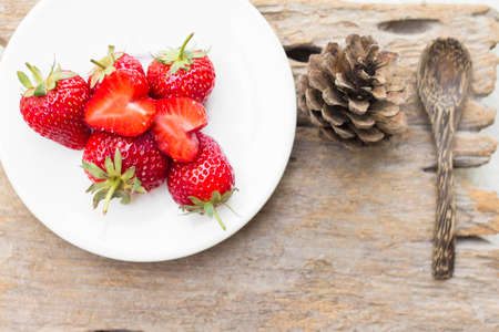 strawberry in a dish placed on the woodの写真素材