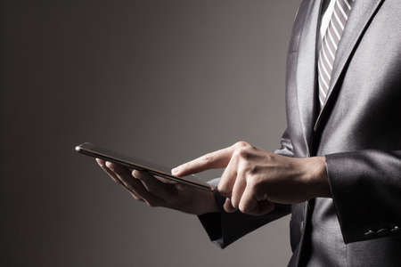 Business man  touching smartphone.
