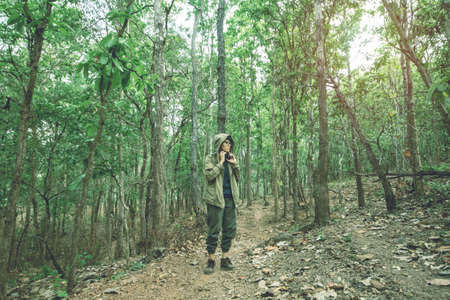 Man standing in the forest tourism and vacation the concept   background.