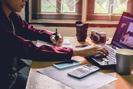 Man's work on my desk light sunset business concept Vintage tone.の写真素材