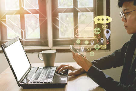 Man working on phone and computer with sunset business i con concept background.