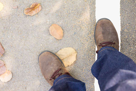 Shoes on the white line on the road.