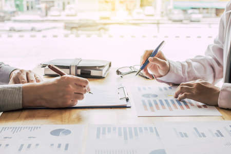 Business people meeting point to discuss, plan and chart the rise and fall of economic.