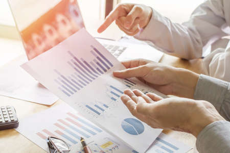 Business meeting pointers to discuss plans and charts for the rise and fall the economy of...