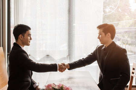 Asian businessmen shaking handsの写真素材