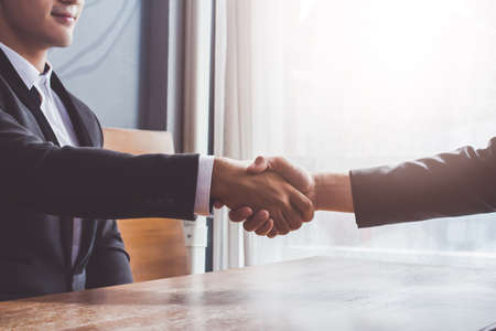 Asia Businessman together create a mutually beneficial business relationship. Economic graph on the tableの写真素材