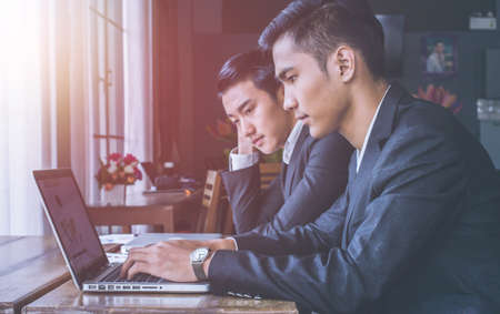 Businessmen working on laptopの写真素材