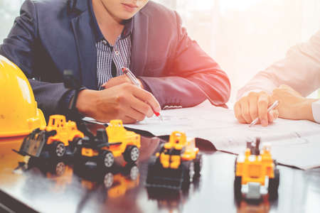 young. two Asian holding pen.meeting business planing architecture, industrial design, building...