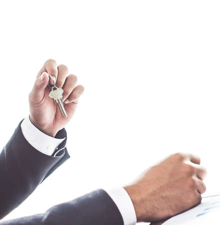 Close up. hand Asia businessman holding office key on white backgroundの写真素材