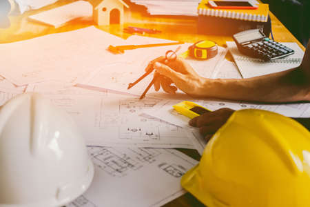 Concept architects, equipment architects On the desk with a blueprint in the office, Vintage, Sunset...
