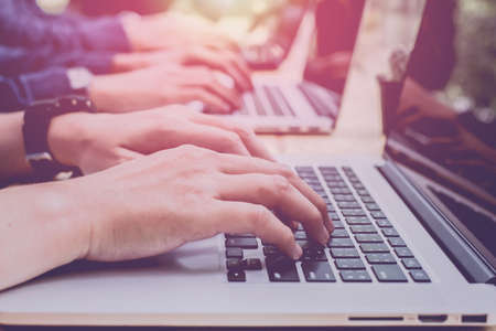 Close up. Man Working on laptop connecting networking Concept,Teamwork,With sunset,Selective Focus.の写真素材