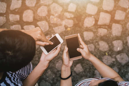 Close up of men hands holding touching mobile phone with blank copy space for your text message in...