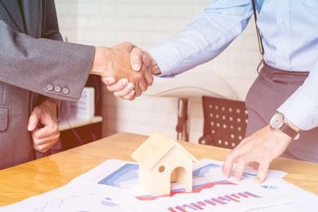 Asian Businessman together create a mutually beneficial business relationship. Economic graph on the tableの写真素材